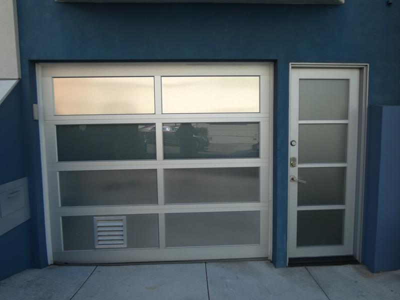 Glass door, clear aluminum frame, frosted glass, single door, in a stucco wall