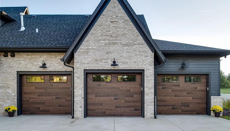 Dark wood plank door, horizontal planks, top windows, three single doors, in a brick wall