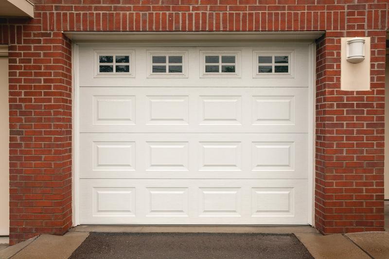 White raised panel door, short panels, top windows, single door, in a brick wall