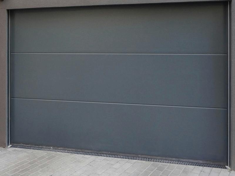 Gray flat door, smooth, single door, in a stucco wall