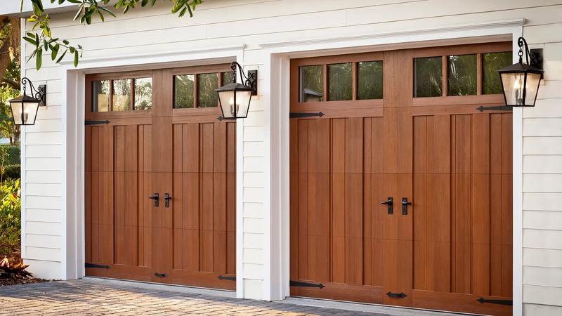 Medium wood carriage door, square windows, strap hinges, two single doors, in a lap siding wall