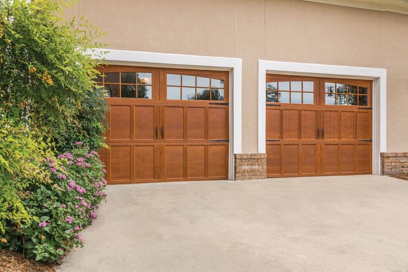 Medium wood carriage door, arched windows, strap hinges, two single doors, in a stucco wall