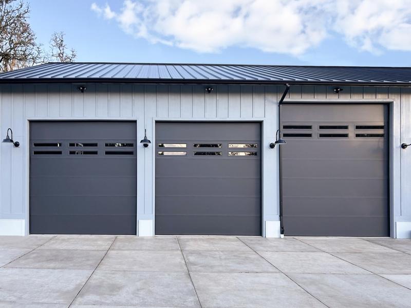 Charcoal flat door, window strip, three single doors, in a board-and-batten wall
