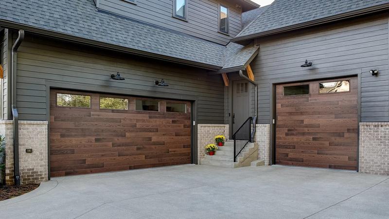 Dark wood plank door, horizontal planks, top windows, double door, in a lap siding wall