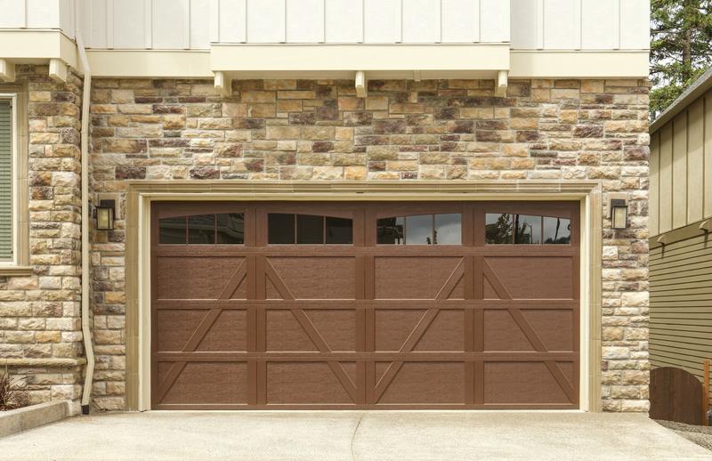 Brown carriage door, Z brace, arched windows, double door, in a stone wall