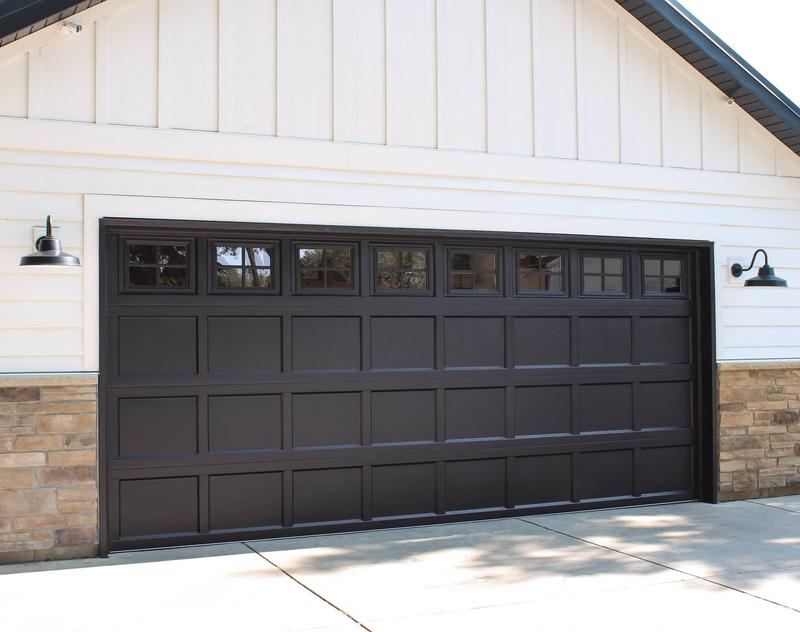 Black shaker door, recessed panels, square windows, double door, in a board-and-batten wall