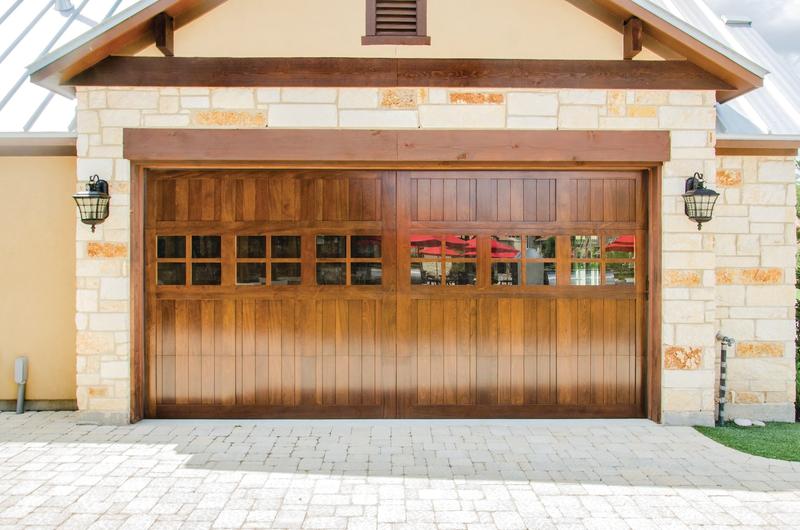 Medium wood door, vertical boards, square windows, double door, in a stone wall