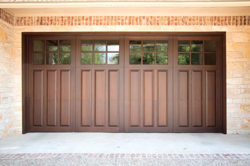 Medium wood door with raised panels, square windows, double door, in a stone wall