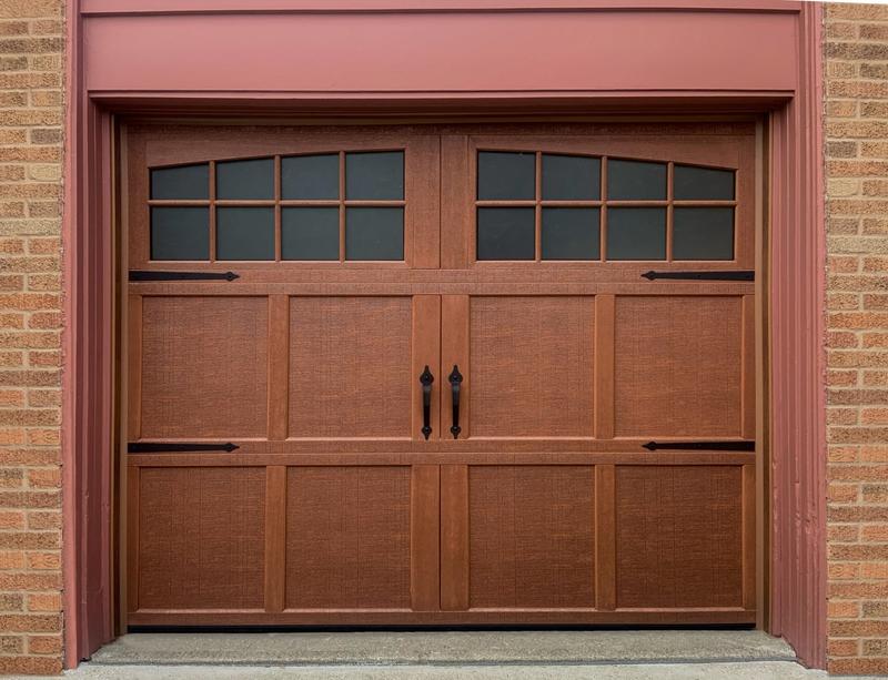 Medium wood carriage door, square windows, strap hinges, single door, in a brick wall