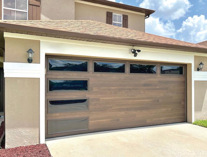 Medium wood plank door, top windows, side window slits, double door, in a stucco wall