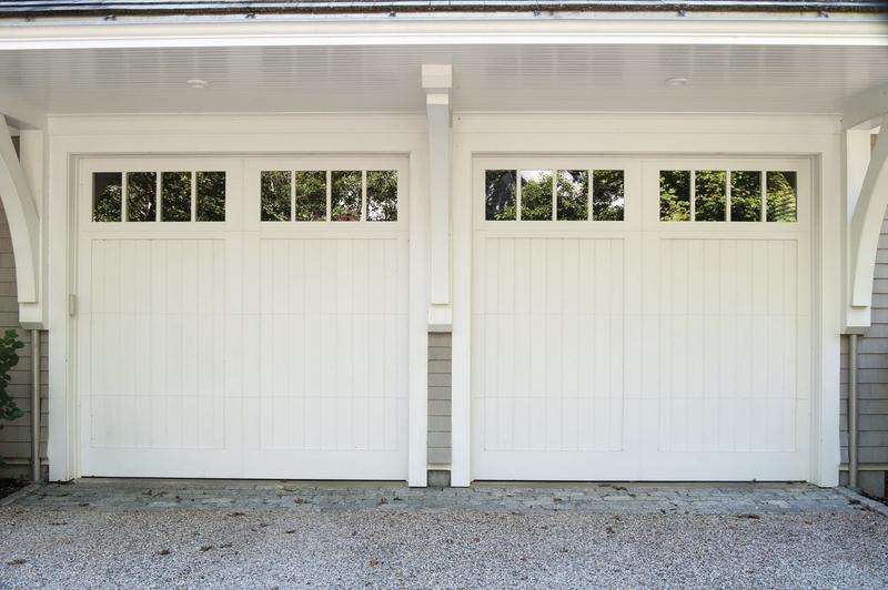 Painted wood door, vertical boards, square windows, two single doors, in a shingle wall