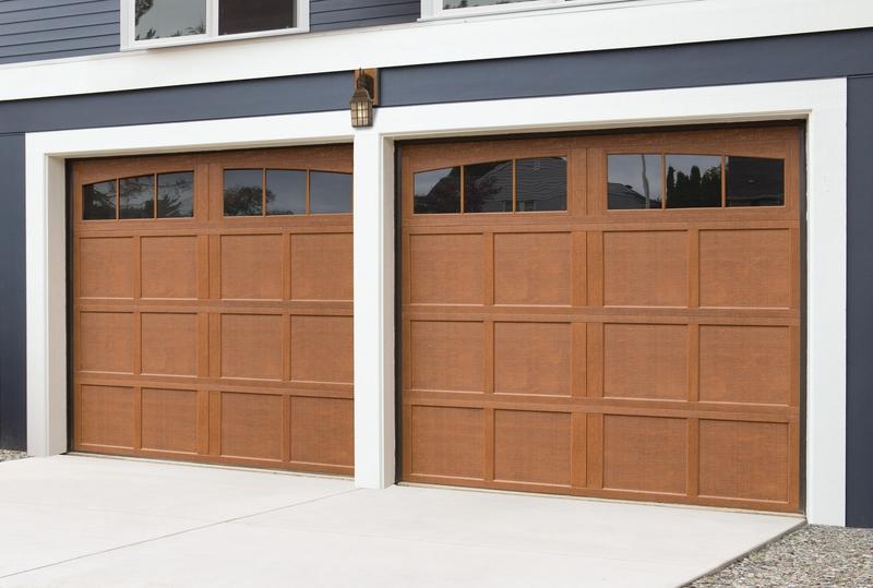 Medium wood shaker door, recessed panels, arched windows, two single doors, in a board siding wall