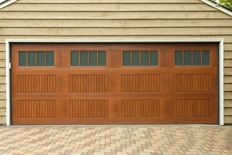Medium wood raised panel door, grooved panels, top windows, double door, in a wood siding wall