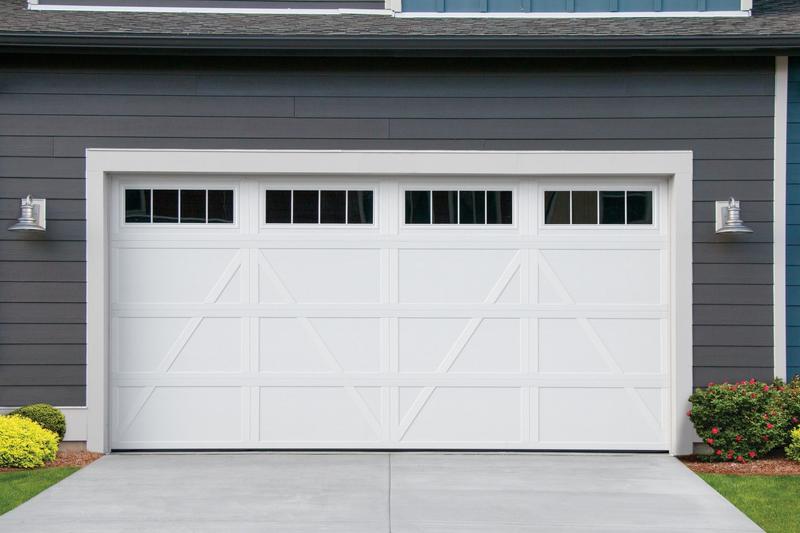 White carriage door, Z brace, square windows, double door, in a board siding wall