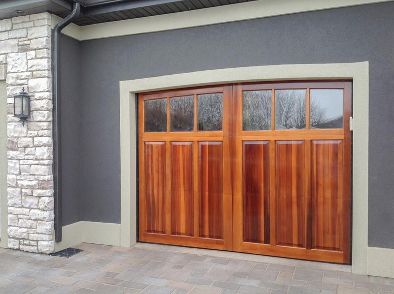 Medium wood carriage door, square windows, double door, in a stucco wall