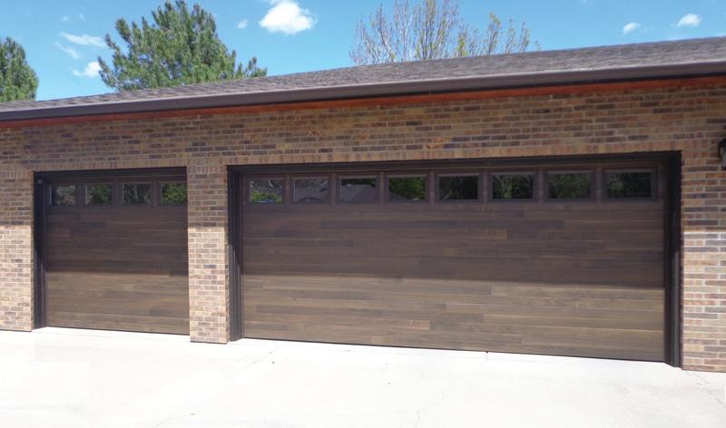 Dark wood plank door, horizontal planks, top windows, two single doors, in a brick wall