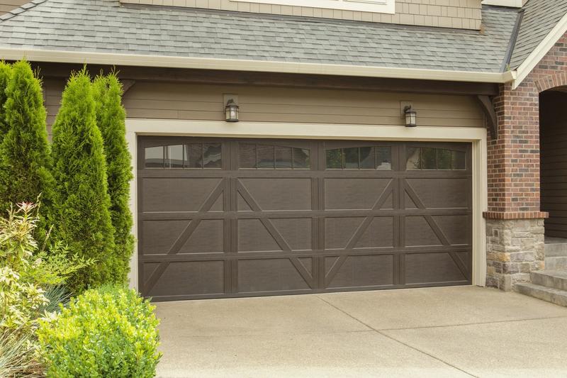 Brown carriage door, X braces, square windows, double door, in a lap siding wall
