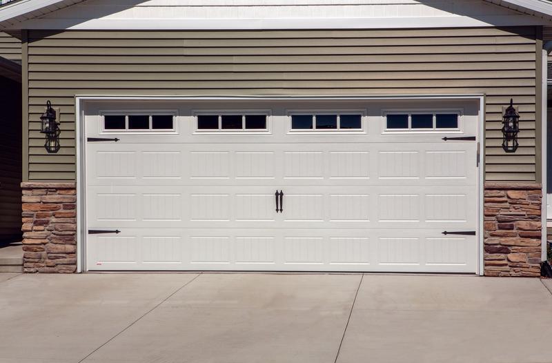 White raised panel door, top windows, strap hinges, double door, in a lap siding wall