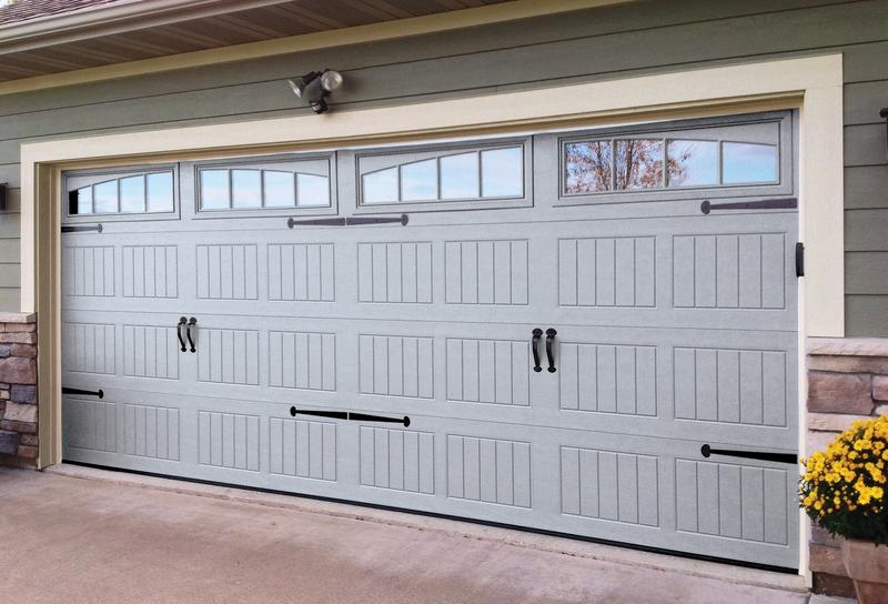 Gray raised panel door, arched windows, black handles, double door, in a lap siding wall