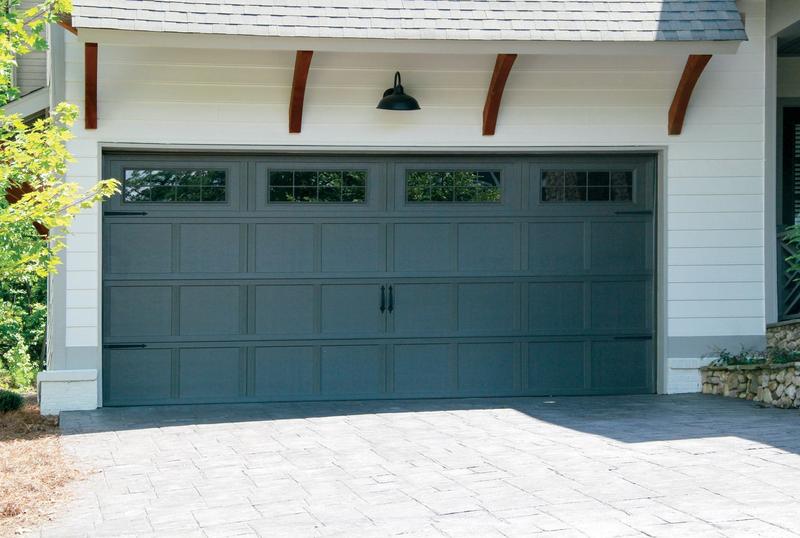 Charcoal carriage door, tall panels, square windows, double door, in a lap siding wall
