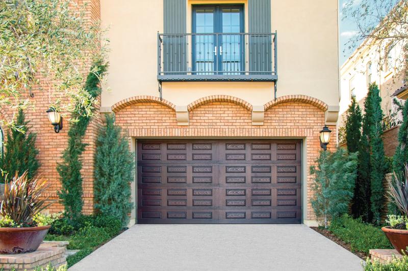 Dark wood raised panel door, short panels, on a stucco home, double door, in a stucco wall