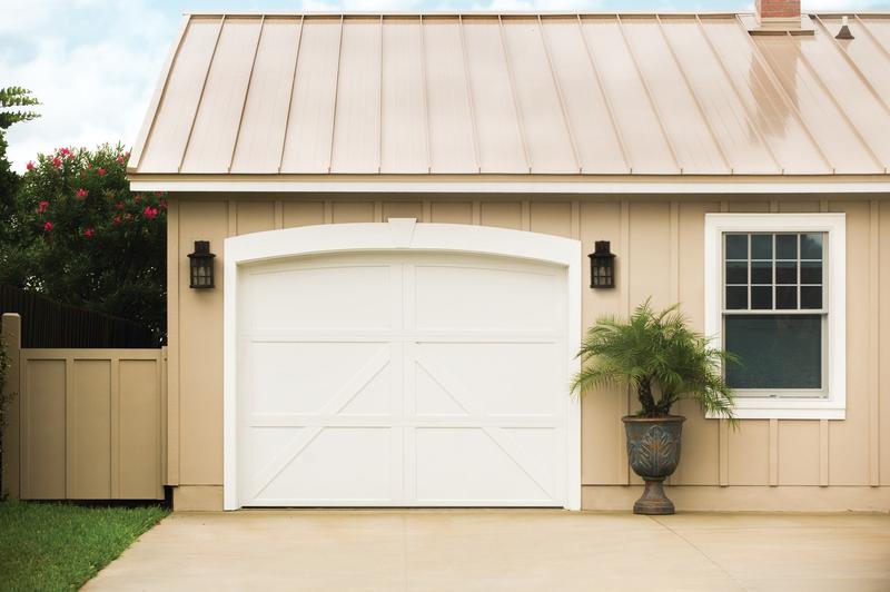White carriage door, Z brace, arched top, on a cottage, single door, in a board siding wall